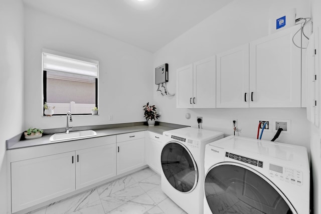 laundry room with independent washer and dryer, cabinets, and sink