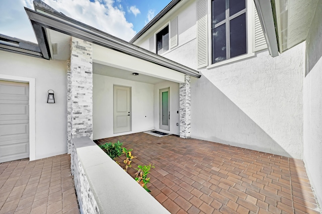 view of exterior entry featuring a garage