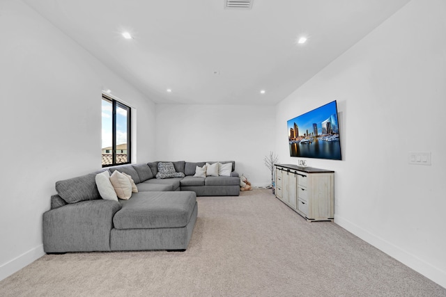 living room featuring light colored carpet and lofted ceiling