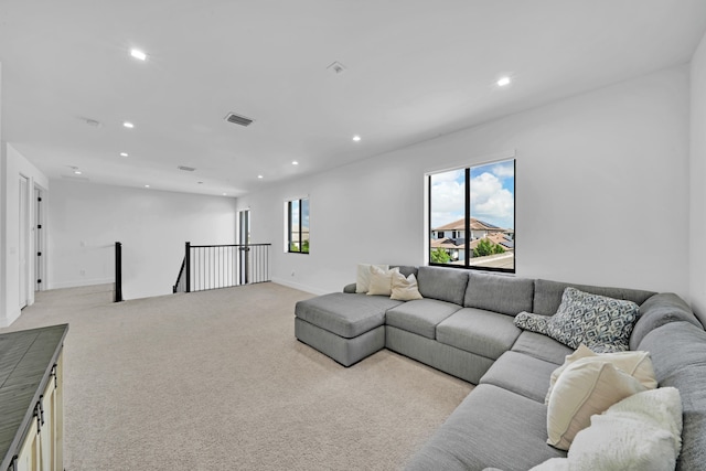 carpeted living room with plenty of natural light