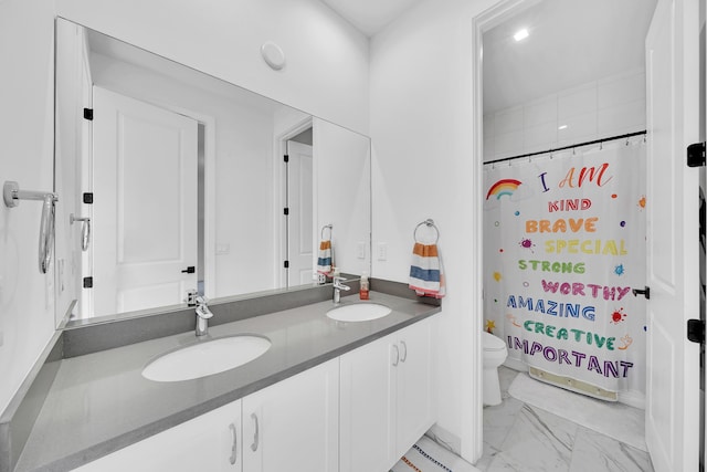 bathroom with toilet, vanity, and a shower with shower curtain