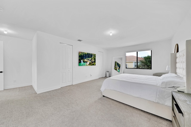 bedroom with light colored carpet