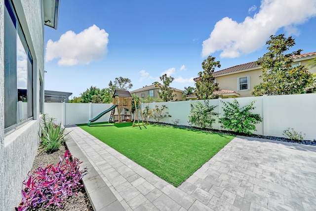 view of yard featuring a patio area and a playground