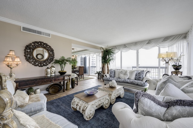 living room with crown molding, light tile patterned floors, and a textured ceiling