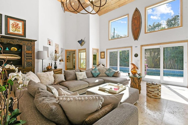 2388 Palm Harbor Dr, Palm Beach Gardens, FL 33410 - living room with a chandelier, a towering ceiling, stone tile flooring, and wooden ceiling