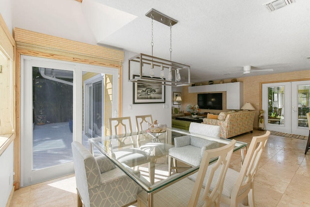 dining space with french doors and ceiling fan