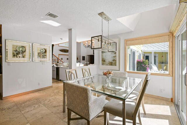2388 Palm Harbor Dr, Palm Beach Gardens, FL 33410 - dining space with a chandelier, baseboards, a textured ceiling, and stairway