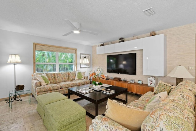 2388 Palm Harbor Dr, Palm Beach Gardens, FL 33410 - living area with a ceiling fan, a textured ceiling, and baseboards