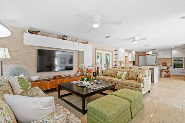 living room with french doors, sink, and ceiling fan