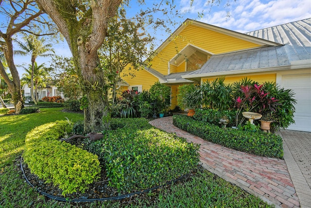 view of front of property with a front yard and a garage