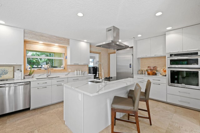 kitchen with a center island with sink, sink, ventilation hood, white cabinetry, and appliances with stainless steel finishes