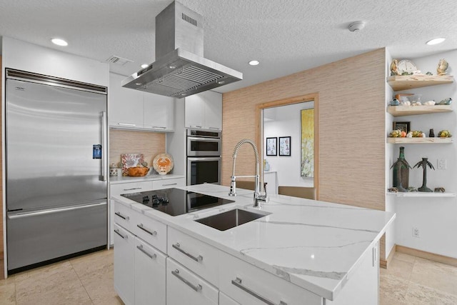 2388 Palm Harbor Dr, Palm Beach Gardens, FL 33410 - kitchen with stainless steel appliances, island exhaust hood, white cabinets, an island with sink, and light stone countertops