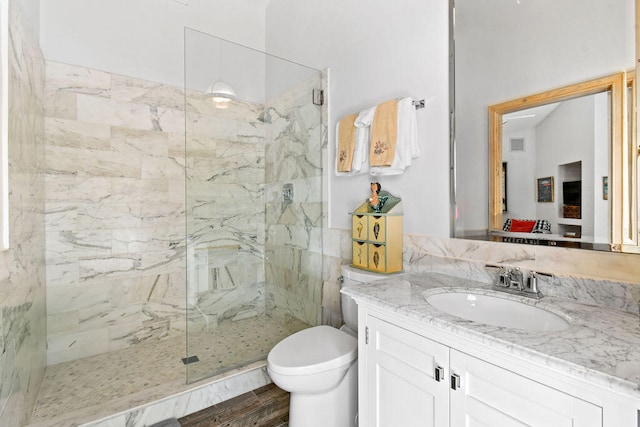 bathroom featuring vanity, wood-type flooring, toilet, and an enclosed shower