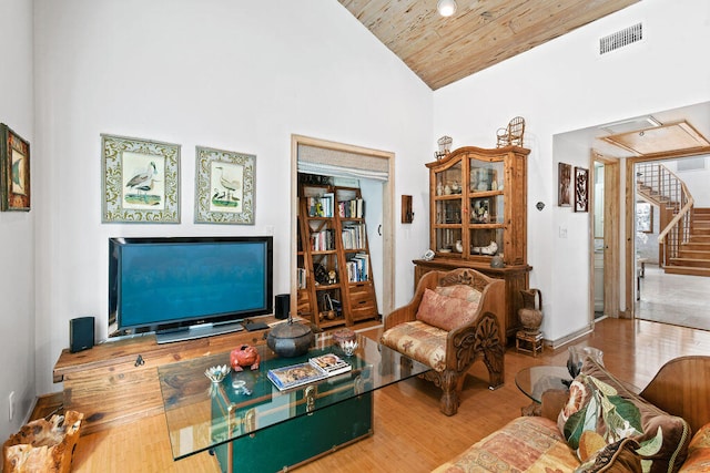 living room featuring high vaulted ceiling, hardwood / wood-style flooring, and wooden ceiling