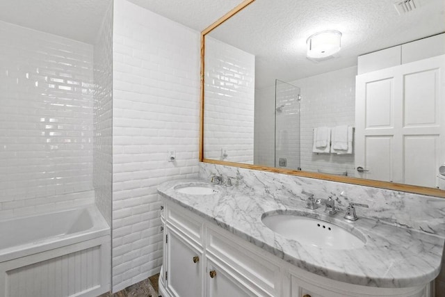 2388 Palm Harbor Dr, Palm Beach Gardens, FL 33410 - full bath featuring a textured ceiling, double vanity, and wood finished floors