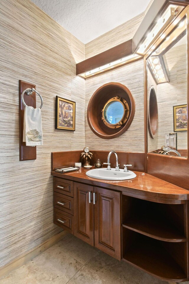 2388 Palm Harbor Dr, Palm Beach Gardens, FL 33410 - bathroom featuring vanity, a textured ceiling, and baseboards