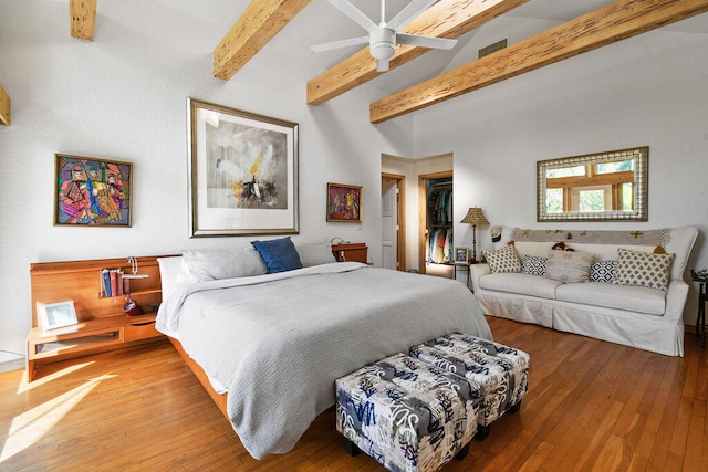 bedroom featuring a closet, ceiling fan, beamed ceiling, and hardwood / wood-style floors