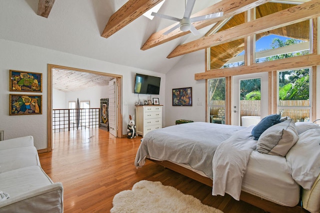 bedroom featuring light wood-type flooring, access to exterior, ceiling fan, beam ceiling, and high vaulted ceiling