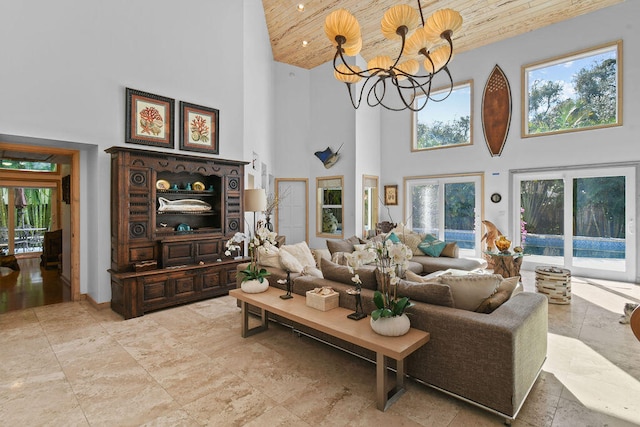 living room with a healthy amount of sunlight, a towering ceiling, and wooden ceiling