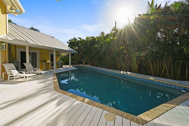 view of swimming pool featuring a deck