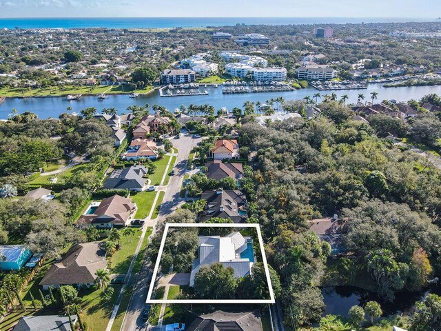 2388 Palm Harbor Dr, Palm Beach Gardens, FL 33410 - aerial view of residential area with property boundaries highlighted and a large body of water