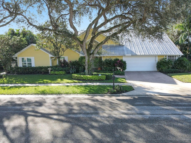 view of front of house with a front lawn and a garage