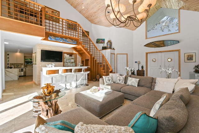 living room featuring a notable chandelier, wood ceiling, and a high ceiling