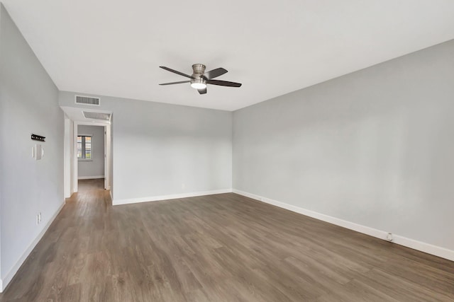 unfurnished room with ceiling fan and dark wood-type flooring