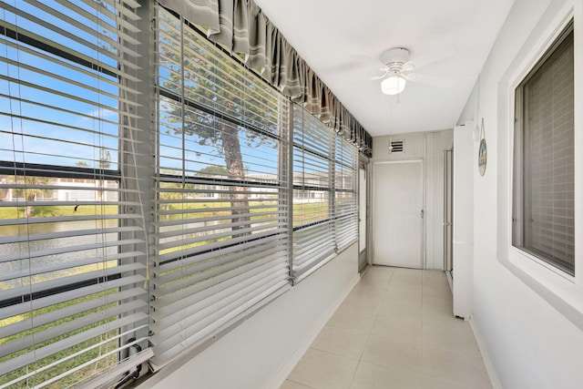 hall featuring light tile patterned floors