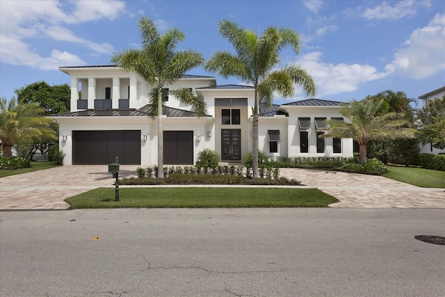 view of front of house featuring a front yard and a garage