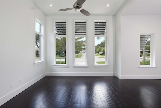 spare room with dark hardwood / wood-style floors and ceiling fan