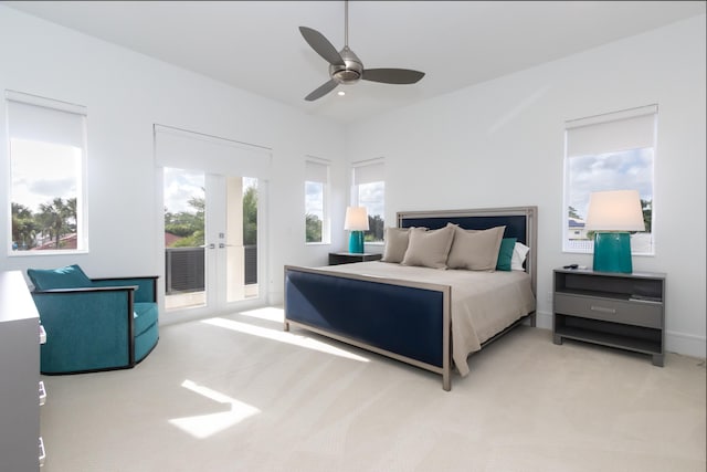 bedroom featuring french doors, ceiling fan, light carpet, and access to exterior