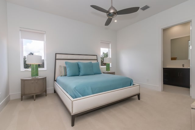 bedroom featuring light carpet, multiple windows, and ceiling fan