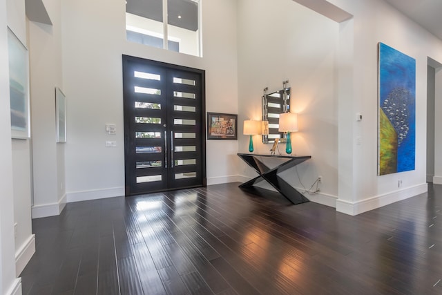 entrance foyer featuring a high ceiling, french doors, and dark hardwood / wood-style flooring