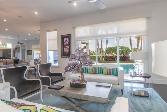 living room with ceiling fan, wood-type flooring, and a wealth of natural light