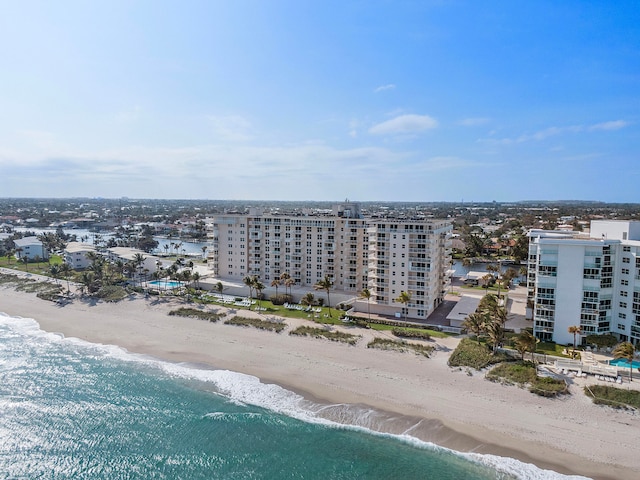 drone / aerial view featuring a water view and a view of the beach