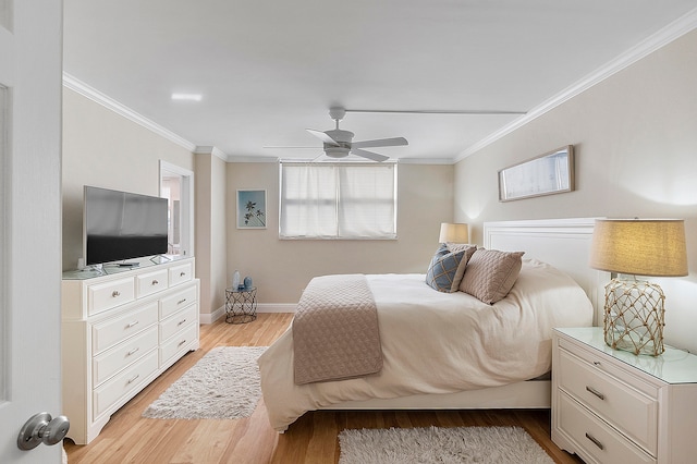 bedroom with light hardwood / wood-style flooring, ornamental molding, and ceiling fan