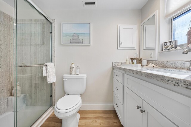 bathroom with baseboards, visible vents, toilet, and a stall shower