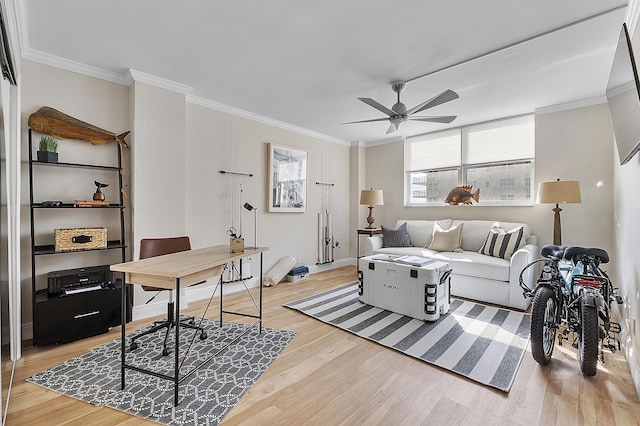 living room with light wood-style flooring, a ceiling fan, and ornamental molding