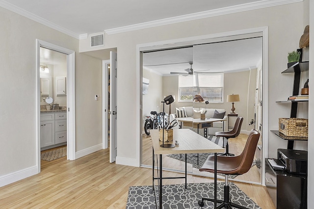 office with crown molding, ceiling fan, light wood finished floors, baseboards, and visible vents