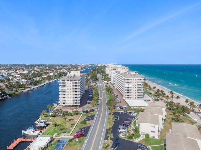 aerial view with a water view and a beach view