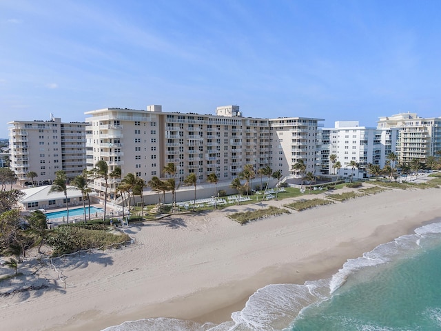 view of building exterior featuring a view of the beach and a water view