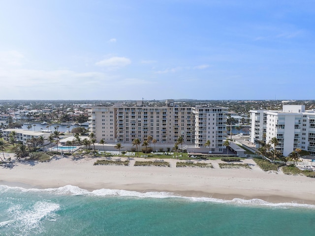 birds eye view of property featuring a beach view and a water view