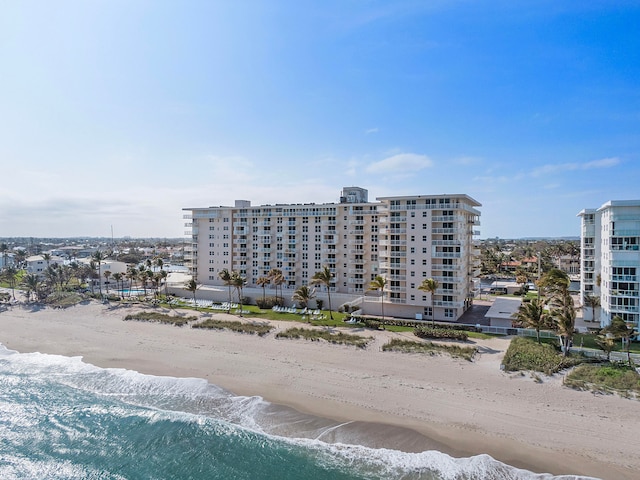 bird's eye view featuring a water view and a beach view