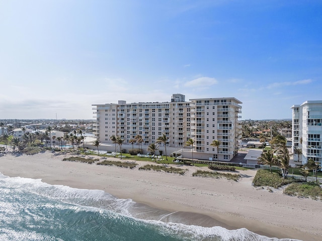 drone / aerial view with a beach view and a water view
