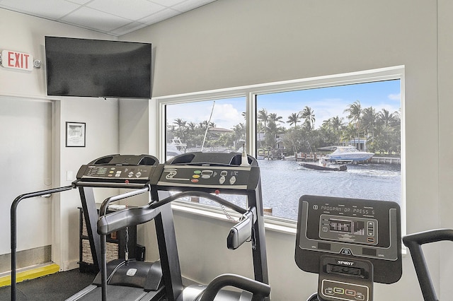 exercise room featuring a wealth of natural light and a drop ceiling