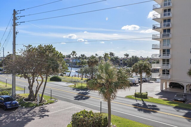 view of street with sidewalks and a water view