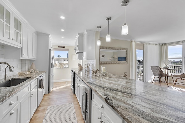 kitchen with beverage cooler, a sink, white cabinetry, and appliances with stainless steel finishes