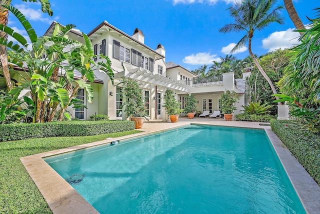 218 Seabreeze Ave, Palm Beach, FL 33480 - back of property with stucco siding, an outdoor pool, a chimney, and a pergola