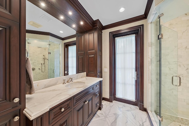 bathroom with vanity, crown molding, and walk in shower